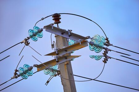 The top of electric pole on blue sky backgroundの写真素材