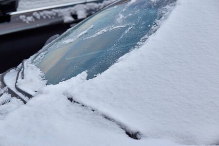 Car windscreen covered with snowの写真素材