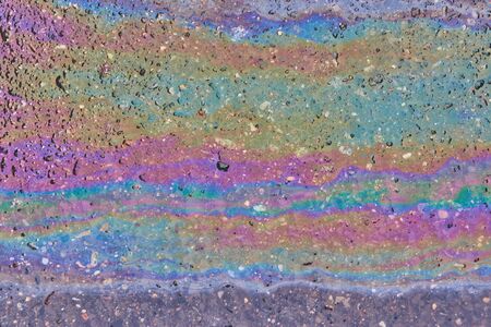 Oil slick on the asphalt road backgroundの写真素材