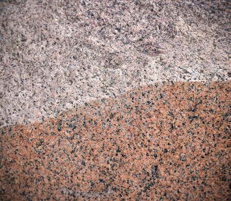 Granite texture, red background with black and gray spots is half natural stone and part polished.の写真素材
