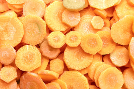Fresh raw peeled carrot slices. Food background