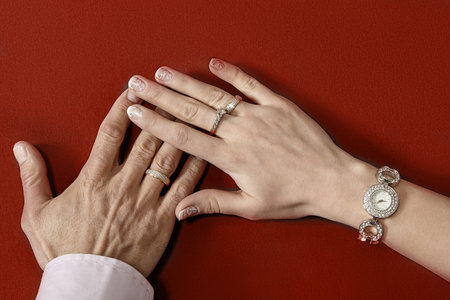 Newly wed couple's hands with wedding rings on closeup