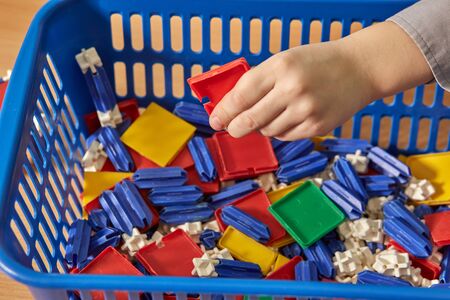 A little boy is playing with a colorful constructor. A child in kindergarten.の写真素材