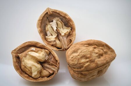 Walnuts and cracked walnut on white backgroundの写真素材