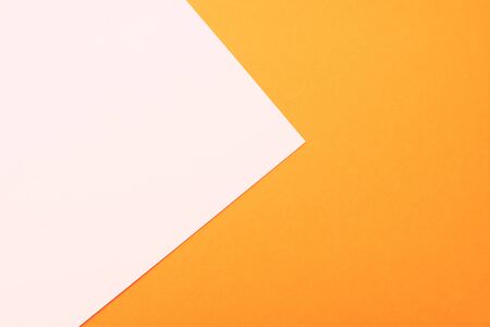 Two colored bright paper texture orange and white as background, top view with place for textの写真素材