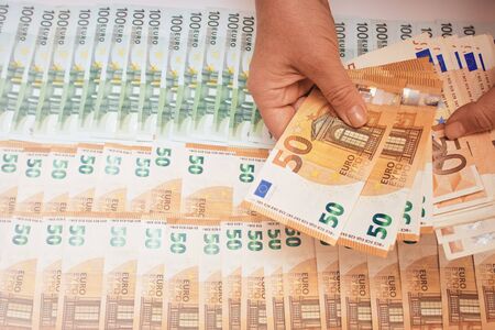 Euro banknotes in female hand. Euro cash background of moneyの写真素材