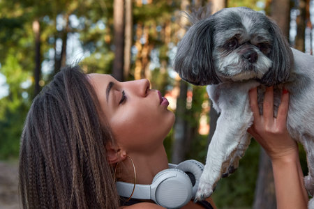 Oung woman with her cute Shih Tzu. Lovely pet