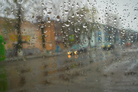 View from the inside of the car during the rain on the city street in defocus. Soft selective focusの写真素材