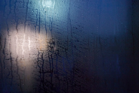 Misted glass. Condensation drops on the window. Background. Blue textureの写真素材