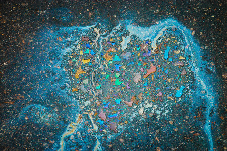 Oil stain on Asphalt road after rain. Abstract close-up background.の写真素材