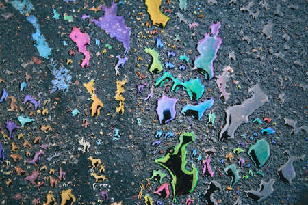 large oil, gasoline stains wet asphalt as a texture or background.の写真素材