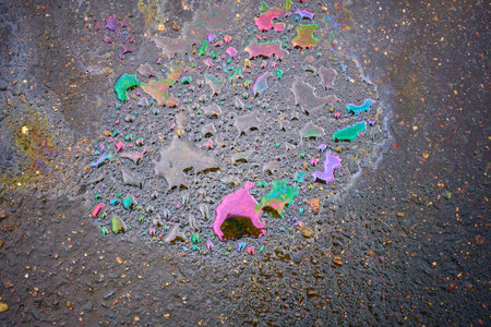 Oil stain on Asphalt, color Gasoline fuel spots on Asphalt Road as Texture or Background.Close-up...