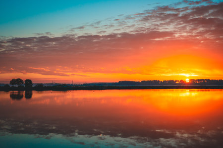 sunrise over the lake in autumn early morningの写真素材