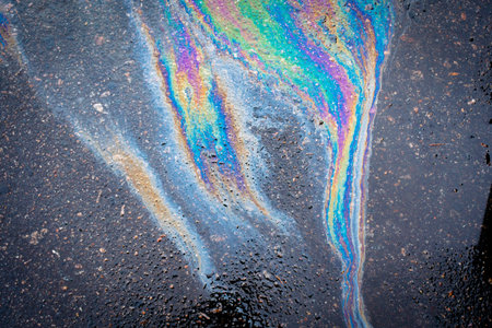 Abstract background from motor oil, gas or petrol spilled on asphalt. environmental pollution...
