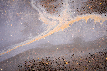 Slick industry oil fuel spilling water pollution. Water with patches of gasoline and oil.の写真素材