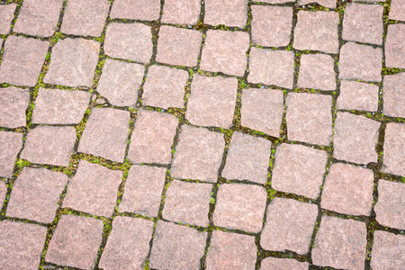 The road is paved with decorative stone. The old road of granite paving stones.の写真素材