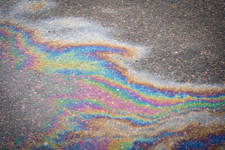Gasoline stains on asphalt. Gasoline spilled on road.の写真素材