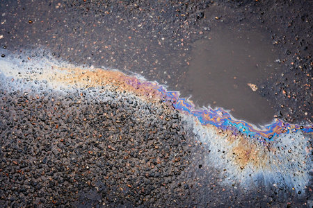 .Abstract background from motor oil, gas or petrol spilled on asphalt. Concept of environmental problems.の写真素材