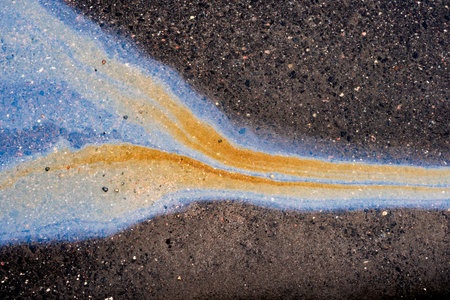 Waste from the oil industry flows down the storm drain with rainwater.の写真素材