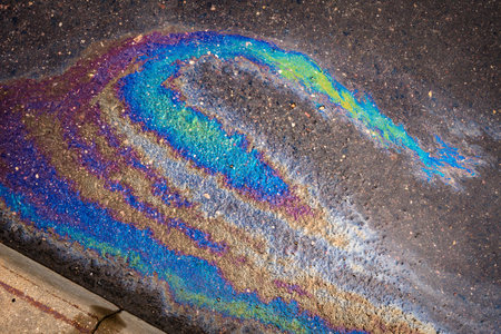 Texture of colorful petrol oil spill on wet pavement.の写真素材