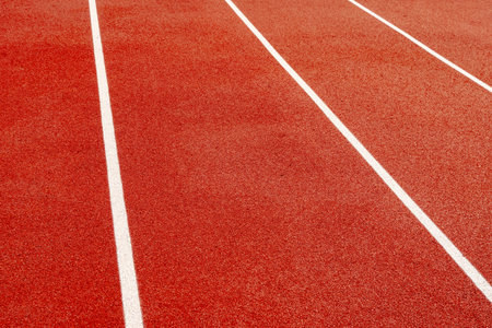 White lines on the red carpet at the athletics and sports stadium.