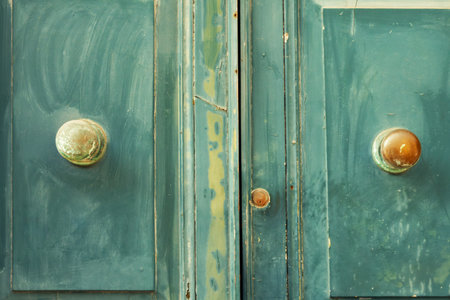 Fragment of an old wooden door with round handles.の写真素材