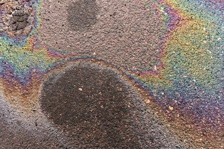 Fuel or oil stains on an asphalt road as a texture or background.の写真素材