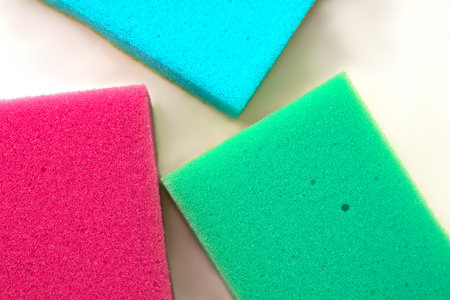 Three sponges of different colors for washing dishes.の写真素材