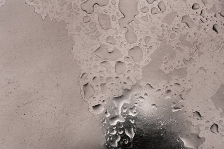 Rain drops on a metal surface as a background or textureの写真素材