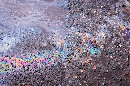 Petrol Oil Pollution Rainbow Gasoline Leak on Pavement.