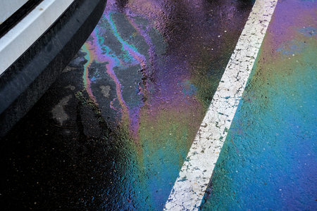 Slick industry oil fuel spilling water pollution. Water with patches of gasoline and oil. Ecological catastrophe.の写真素材