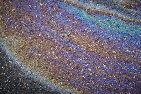 Vibrant oil patch drawing attention on the asphalt pavementの写真素材
