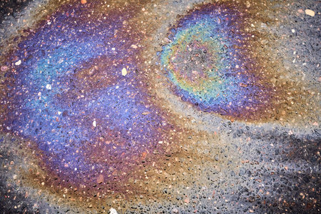 Eye-catching oil stain with vivid hues on the pavement of the asphaltの写真素材