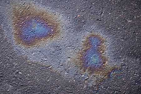 Asphalt oil stain, colorful gasoline spills on the road surface as a texture or background.の写真素材