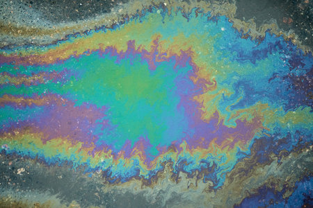 Brightly colored oil slick creating a striking abstract pattern that captivates the imaginationの写真素材