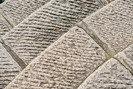 Textured Stone Pavement Showing Intricate Patterns in a Quiet Outdoor Setting During Daylight Hoursの写真素材