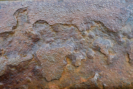 Textured Surface of Weathered Metal Showcasing Rust and Decay in an Industrial Setting.の写真素材