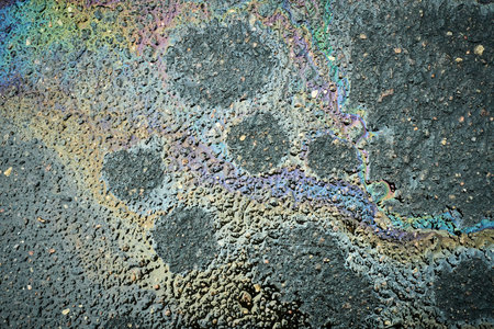 Oil Slick Creates Colorful Patterns on Asphalt After Recent Rainの写真素材