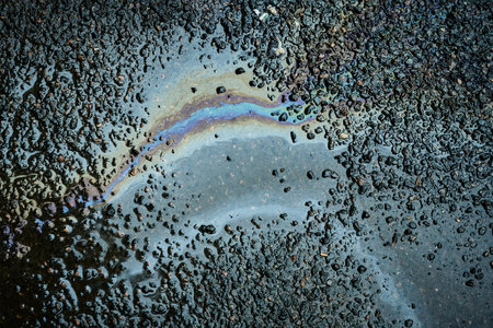 Puddle of water on the asphalt road. Abstract background for design.の写真素材