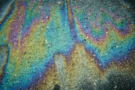 Oil spill on the asphalt road. Abstract background and texture for design.の写真素材