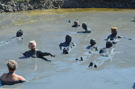 Happy campers bathing in the mud volcano "Tizdar" on the Azov Sea Russia, Krasnodar regionのeditorial素材