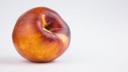 Fresh juicy peaches on a white plate. Close-up Fresh organic peaches nectarine on a white plate.の写真素材