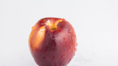 A drop of water flows down a fresh juicy peach. Fresh organic Peach covered with dew drops. Fresh...