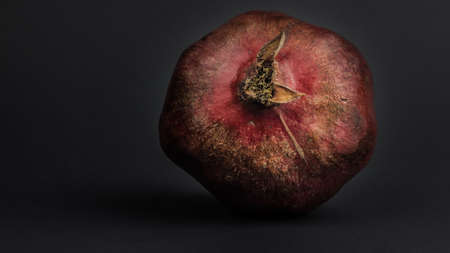 Ripe juicy pomegranate lies on grayの写真素材