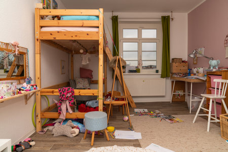 Mess in the children's room. Scattered things and toys, books. parentingの写真素材