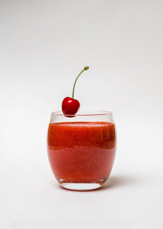 Glass with strawberry smoothie and on a white background. Summer drink. Vitamins, diet, proper nutrition, veganの写真素材