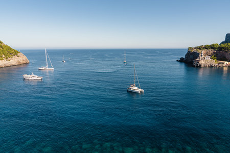 Elegant yachts moored anchor in picturesque harbor Port de Soller.Calm sea surface, sunny day....