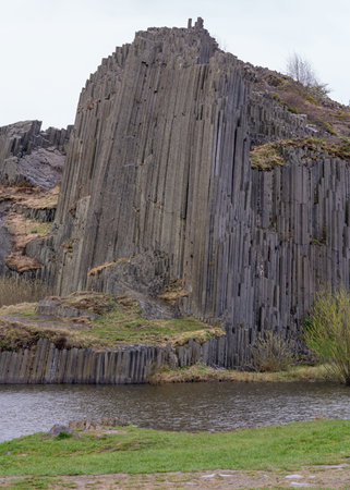 Tall and gray basalt columns. Basalt rock Panska skala in Kamenice Senov, Czech Republic
