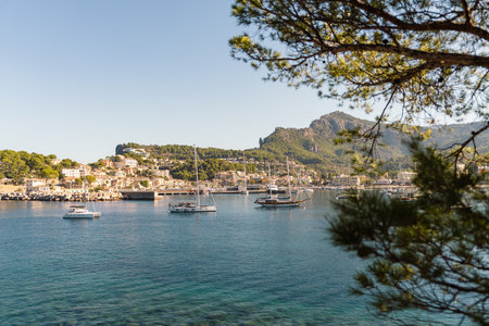 Picturesque view of moored motor boats, yachts along coast Port de Soller, Spain. Calm sea surface, sunny day atmosphere maritime romance. Travel, vacation at sea, yachting, coastal life.の写真素材
