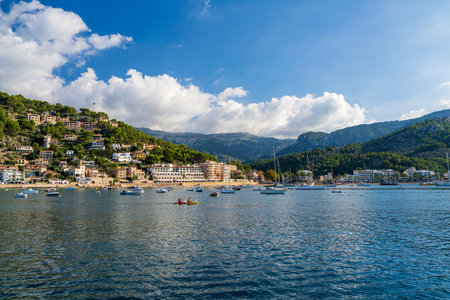 Port de SÃ³ller. Mallorca Island, Spain, October 2nd, 2023. Beautiful beachfront meets azure waters of the sea. Tramuntana Mountains.の写真素材